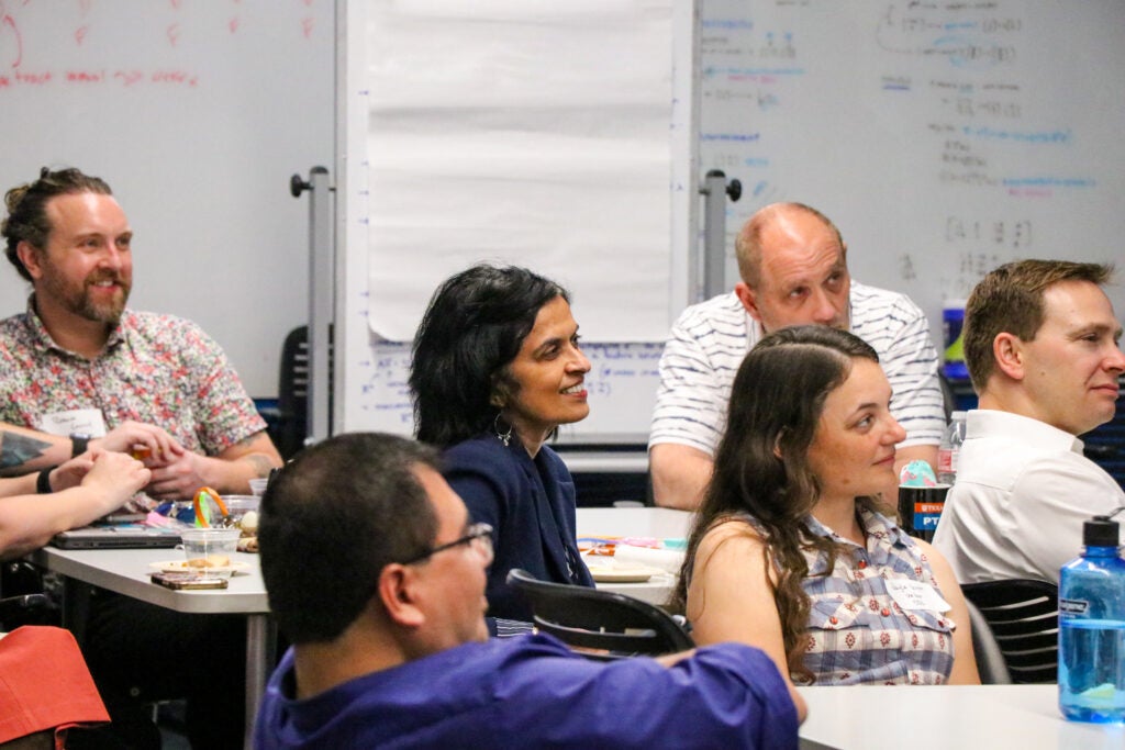 Group of individuals listening to a presentation