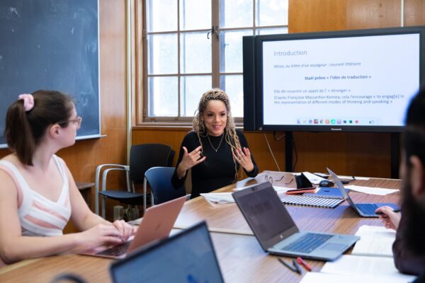 Faculty presenting in a boardroom-style room